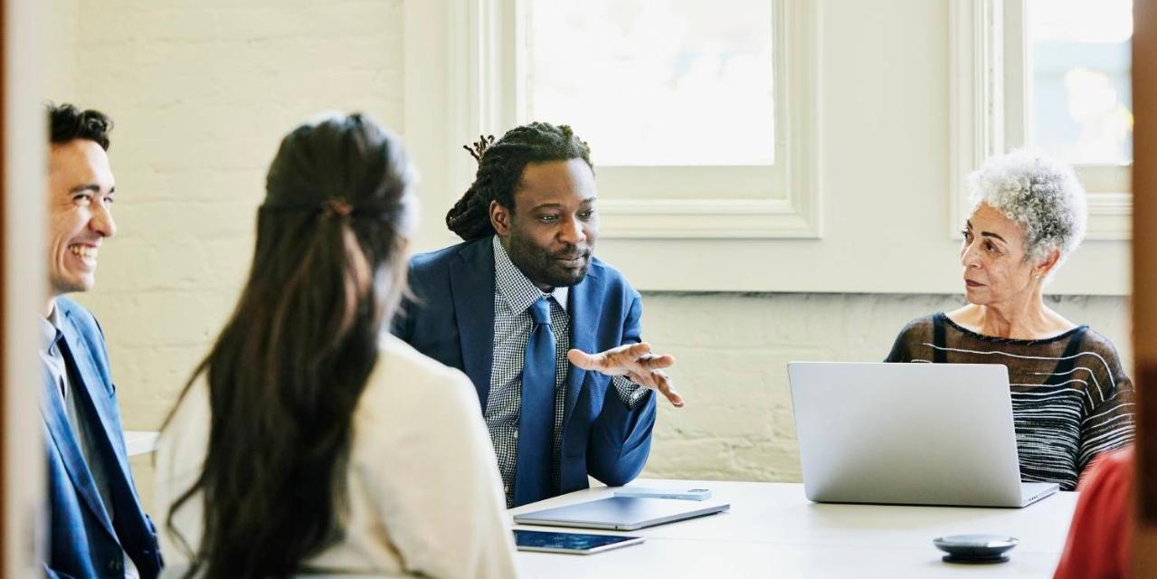 Businessman leading team meeting in conference room