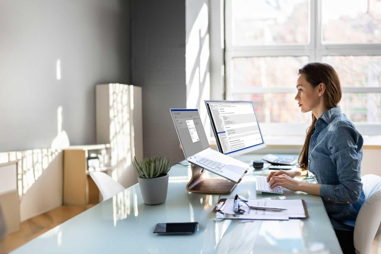 female programmer looking at data on two monitors