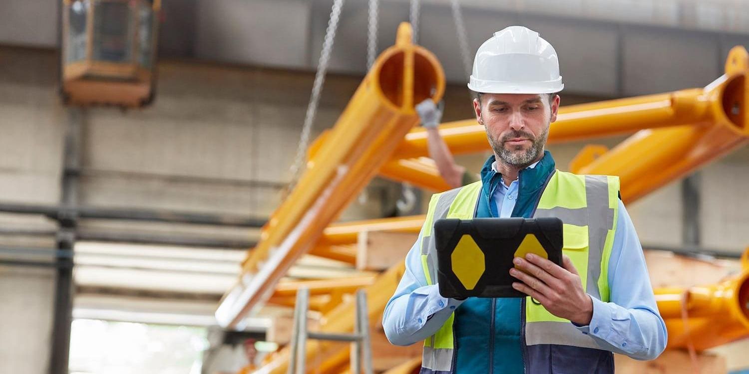 Engineer holding tablet in factory