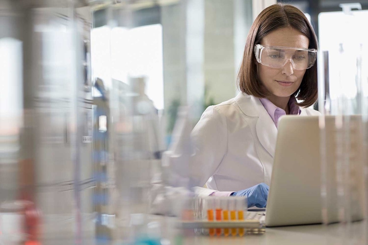 Woman in a lab on a laptop