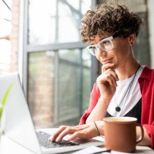 Woman in red sweater at computer