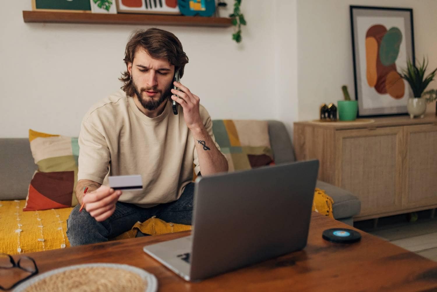 Man on phone holding a credit card