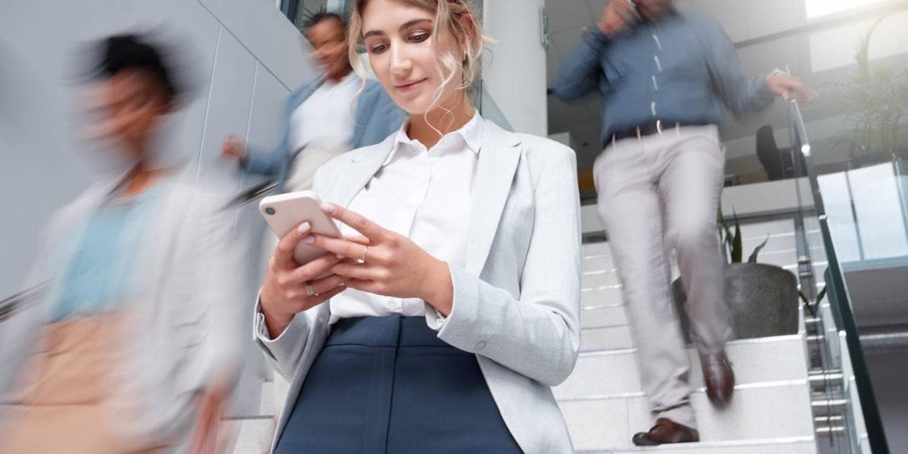 Woman looking down at mobile phone