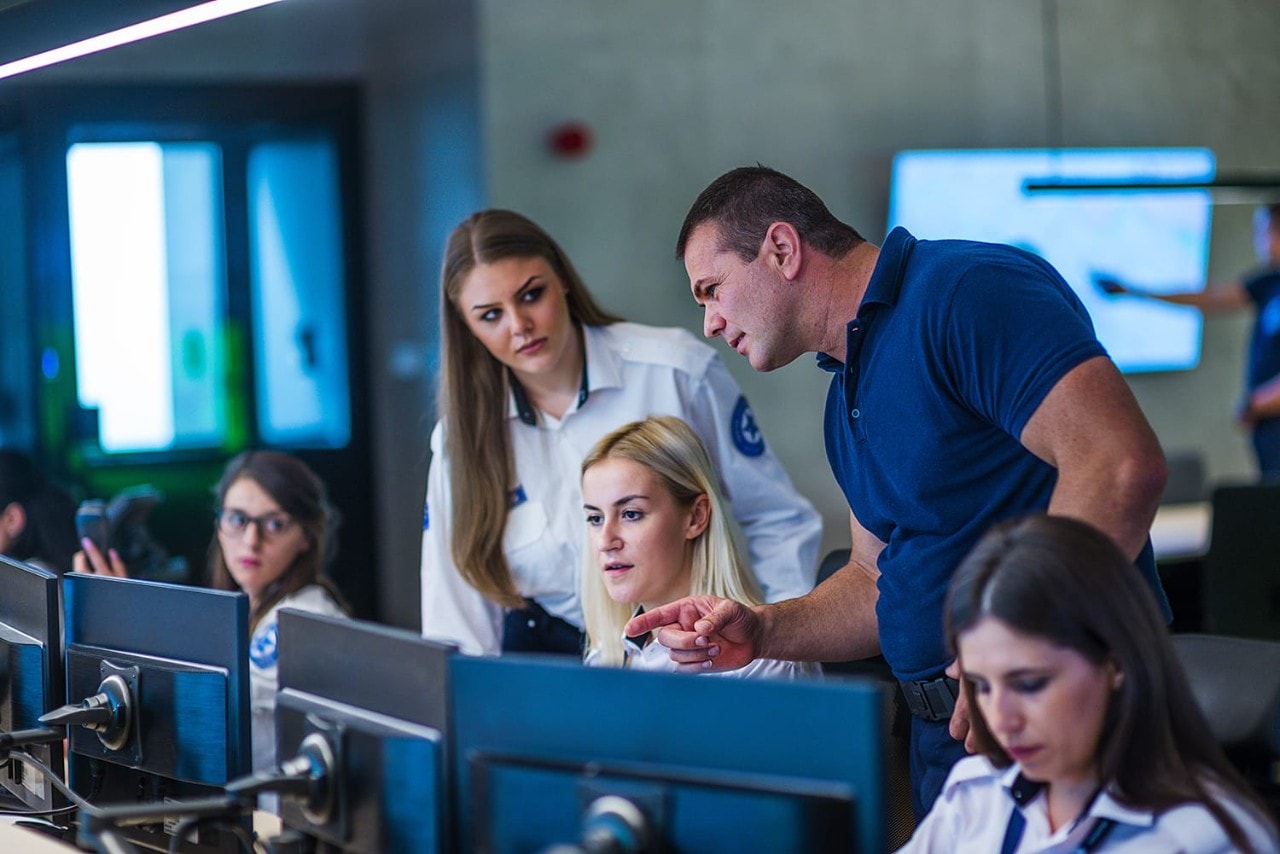 Police officers monitoring screens