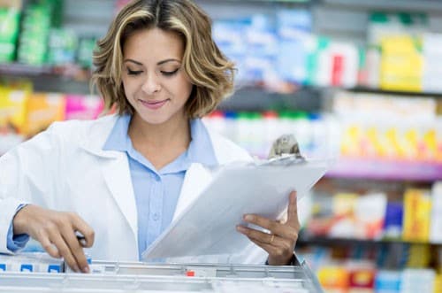 Pharmacist doing inventory at the drugstore