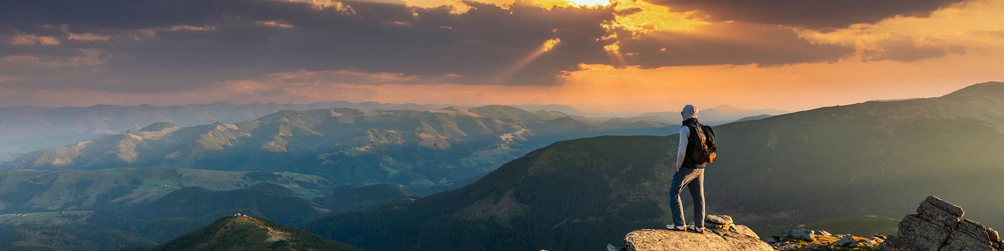 Man on mountain looking into distance