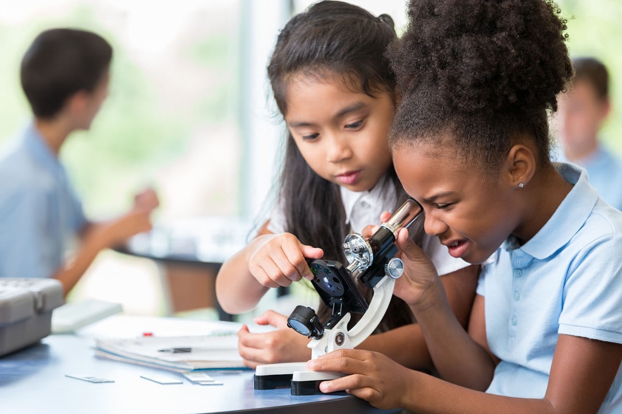 Children looking through microscope