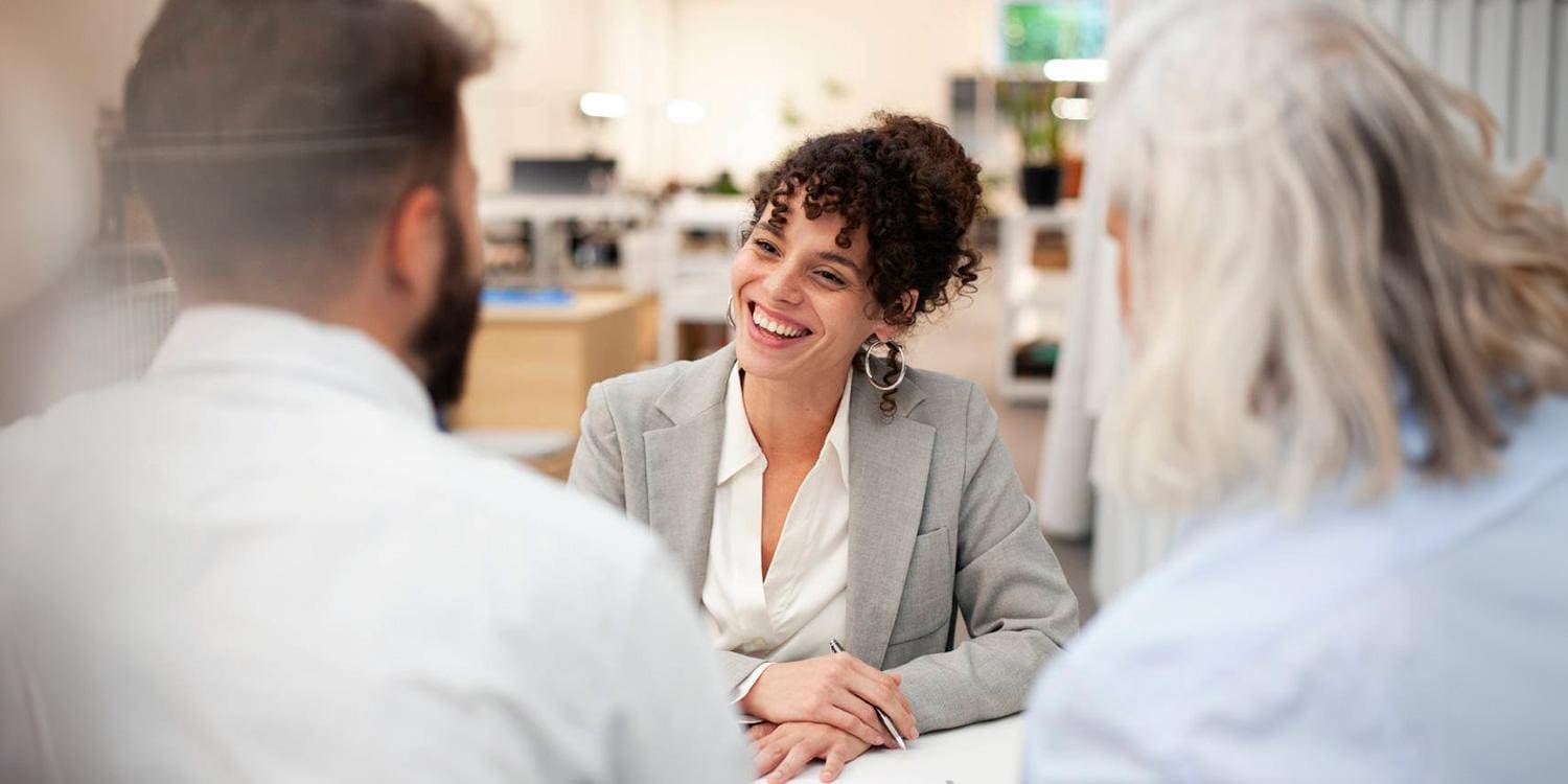 Smiling woman meeting with two people