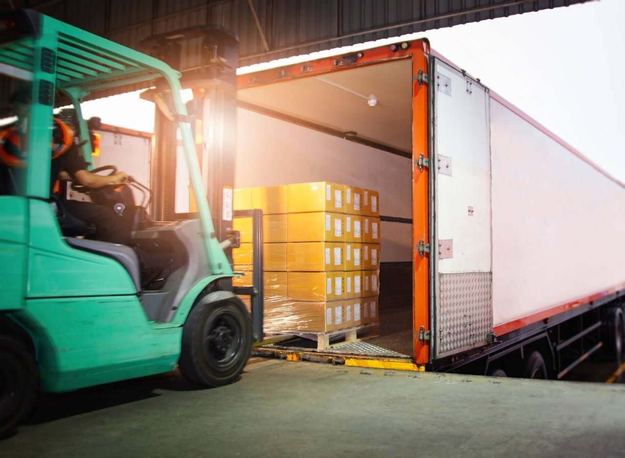 Forklift loading boxes into truck