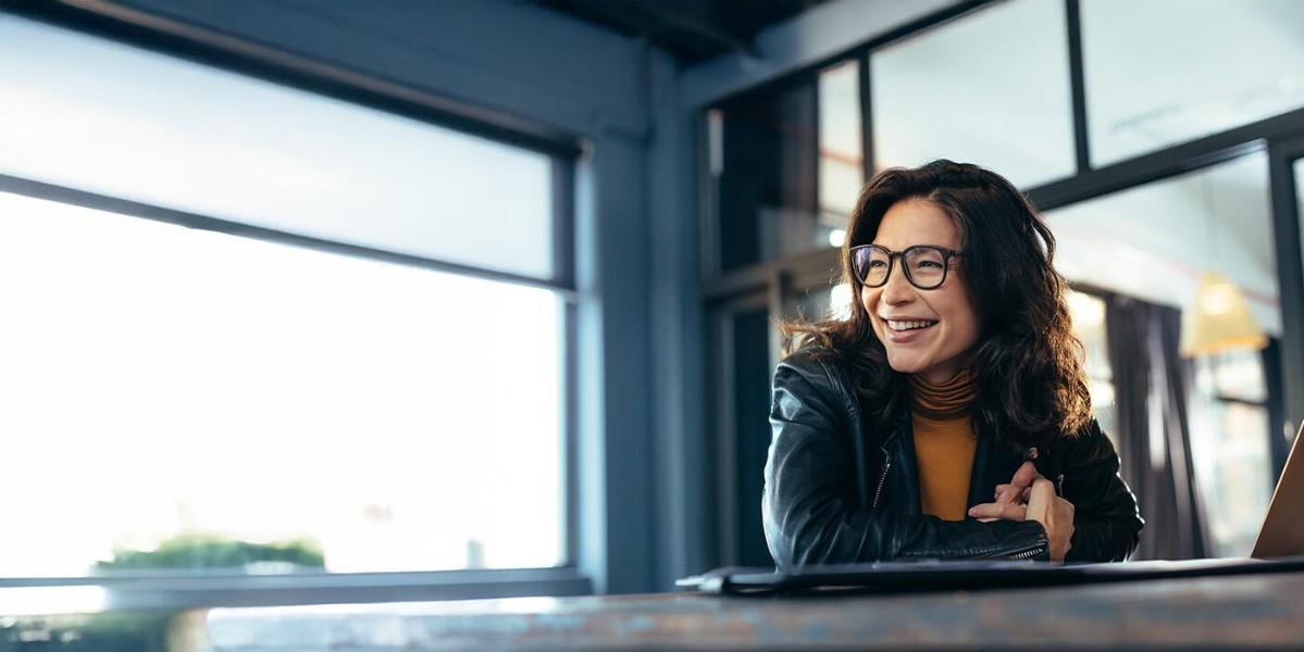 Smiling business woman at her computer