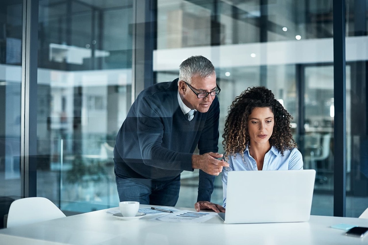 woman and older man in a office working together