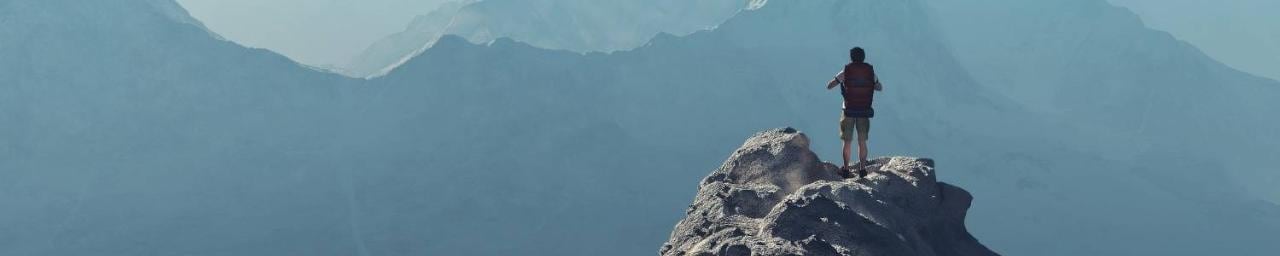 Man looks out over mountains