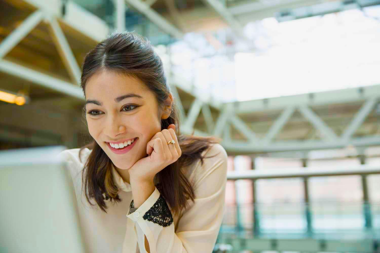 Happy Woman Looking at Computer Screen