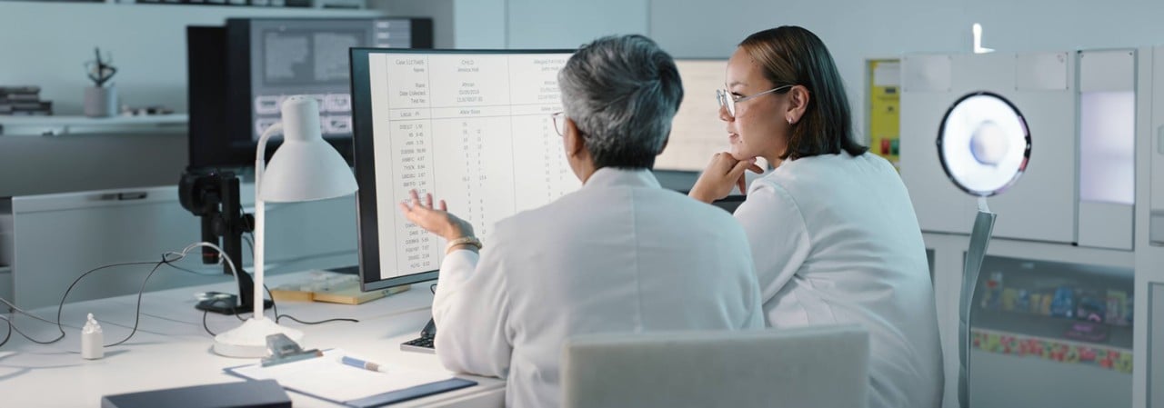 Female scientists working on computer