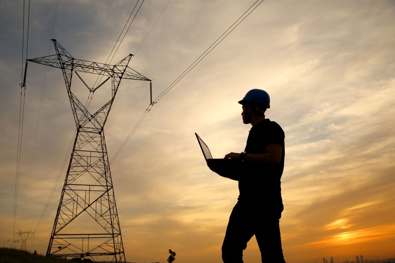 Engineer examines power lines