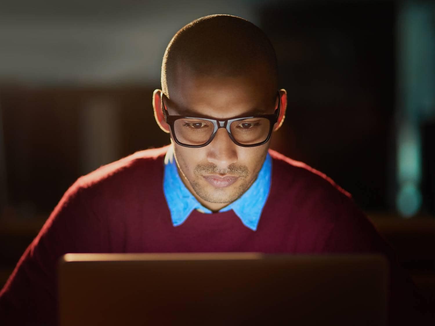 Man with glasses and blue collar