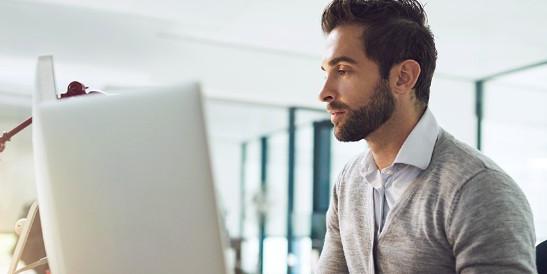 Young business man at desktop computer