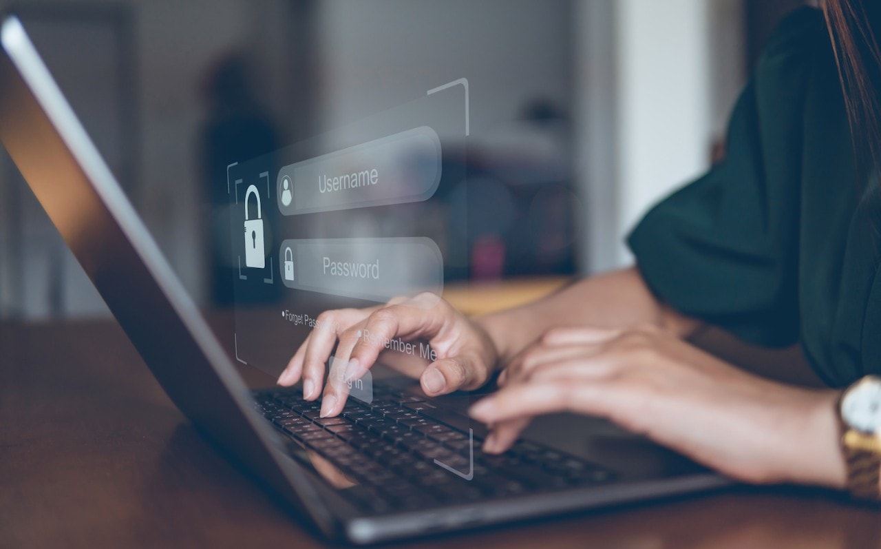 Woman entering login information on laptop