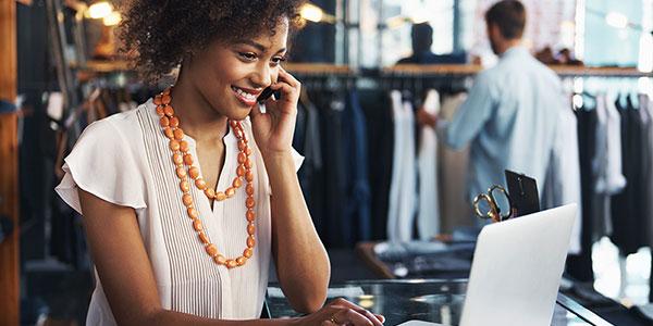 Woman working on laptop smiling