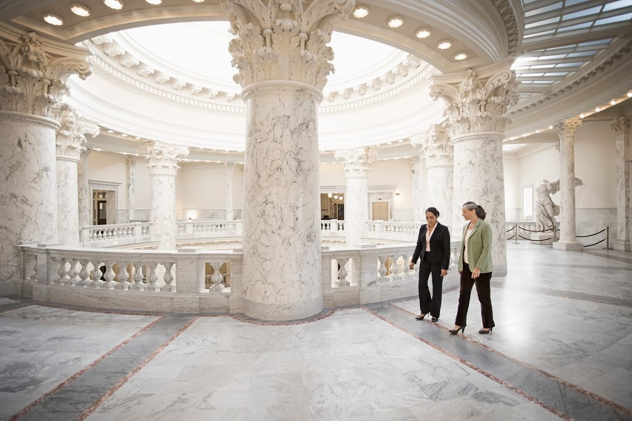 Two people walking through a government building