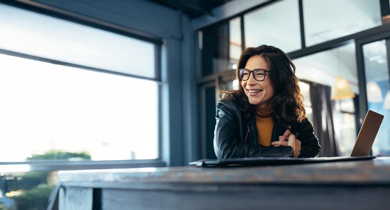 Smiling businesswoman at her computer