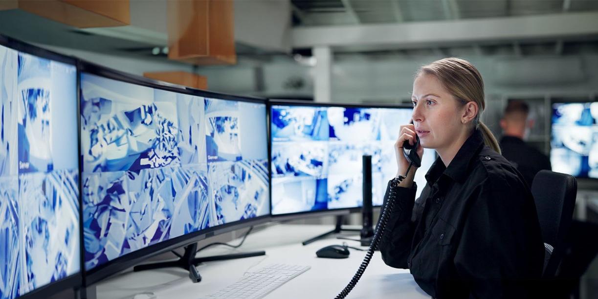 Female security agent monitors activity feed